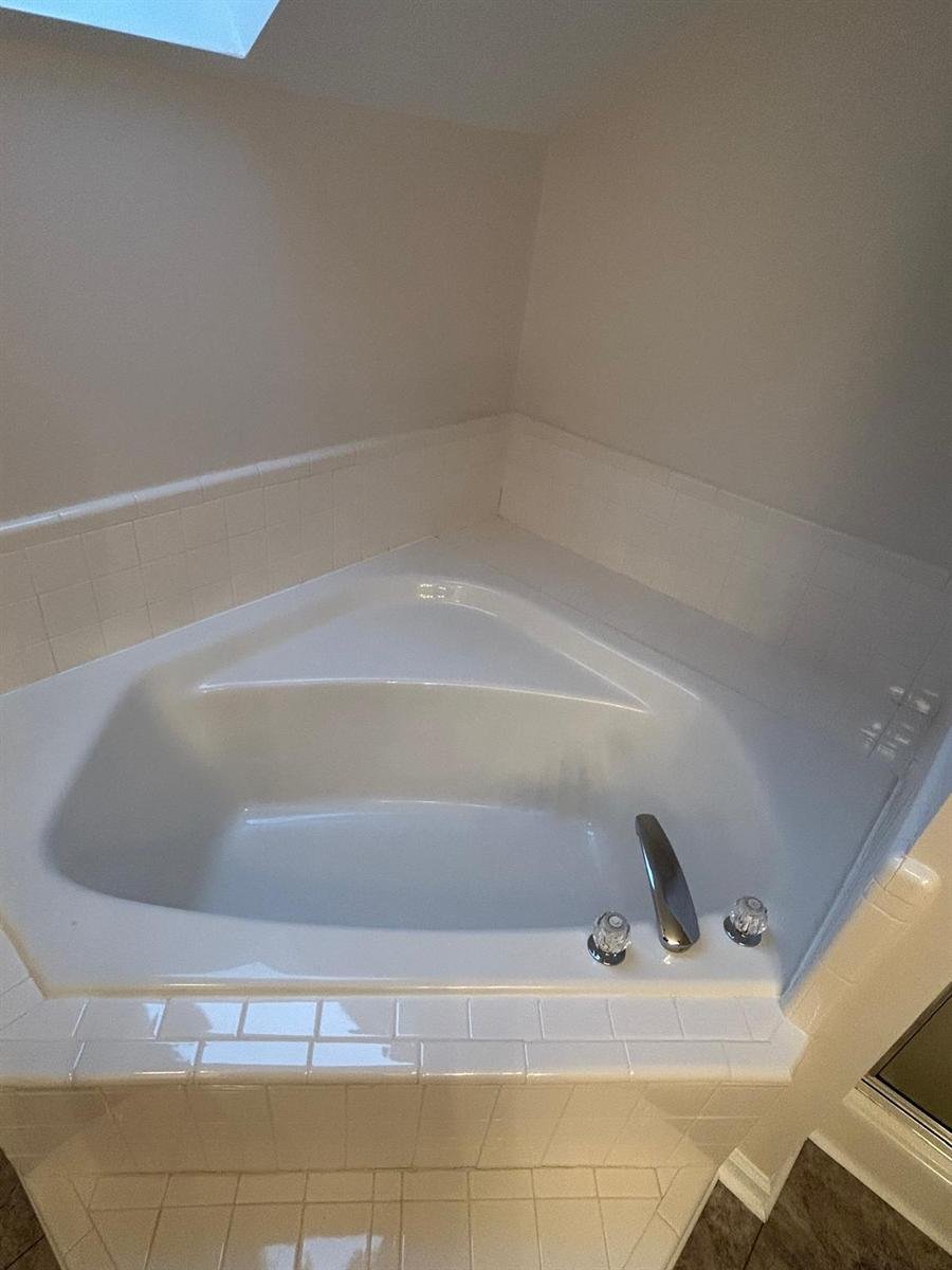 Corner soaking tub and surrounding tile deep cleaned