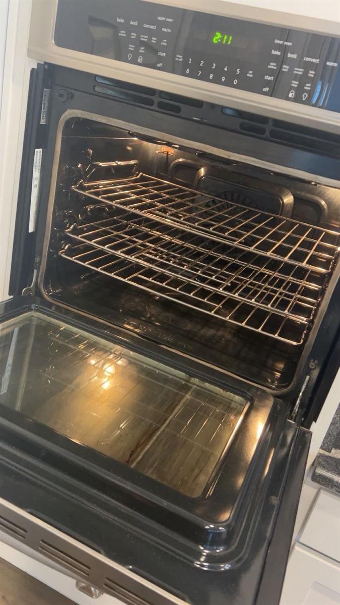 Interior racks of a wall oven before the deep clean